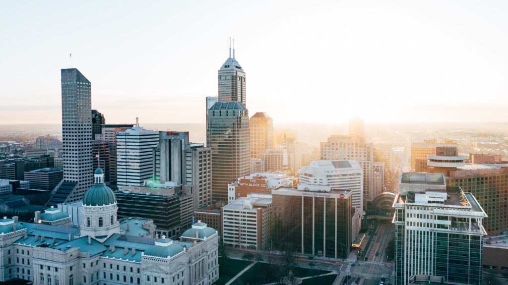 Skyline image at sunrise of a downtown city. Parity helps buildings with building performance standards compliance.