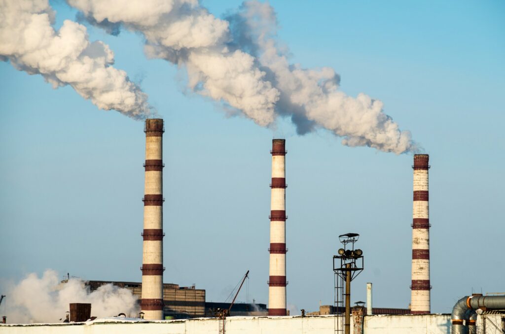 Image of smoke rising from a power plant. The EPA's Greenhouse Gas Equivalencies Calculator is a helpful tool to see conversions.