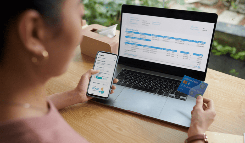 A woman is paying her utility bill while checking Pi. Working with Parity means guaranteed savings on your utility bill.