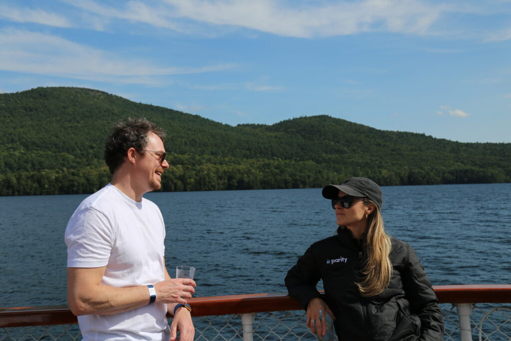 Brad Pilgrim with Vanessa Radman at the Parity 2024 retreat on a boat in a lake