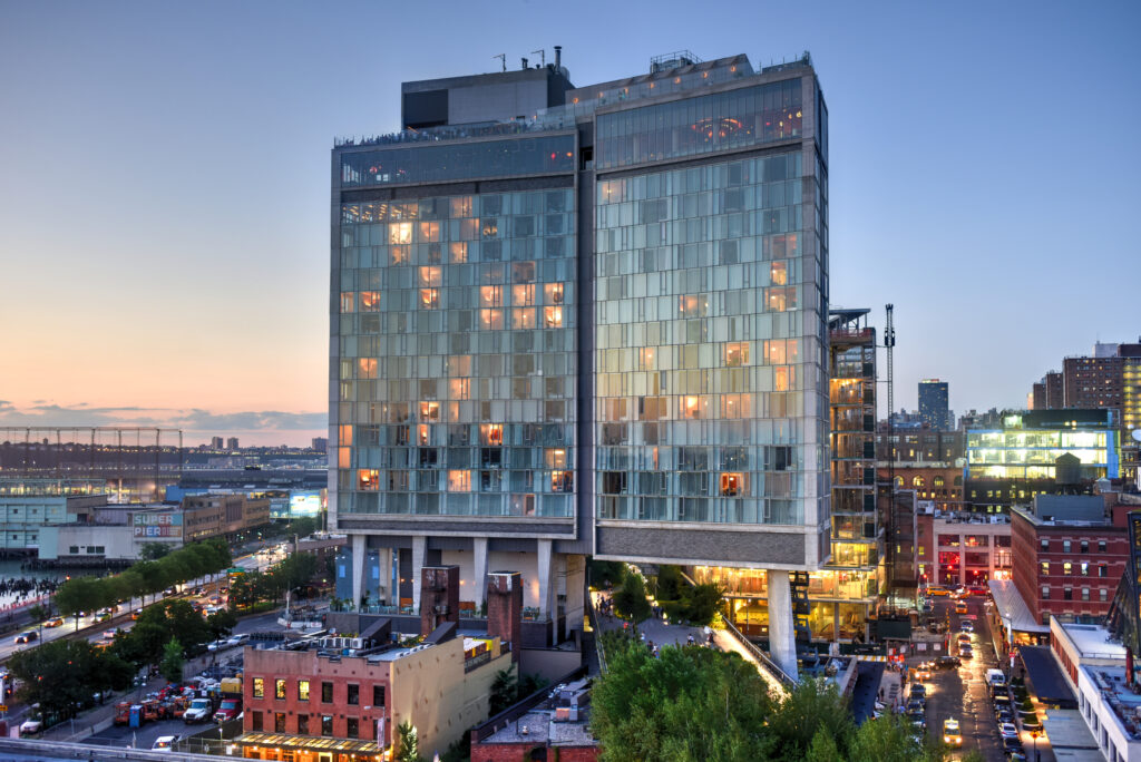 An example of the kind of hotels Parity can work with. This image is of a tan hotel with glass windows in front of a blue sky.